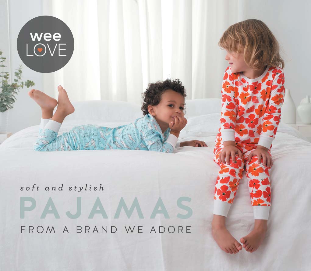 Kids in pajamas sitting on bed