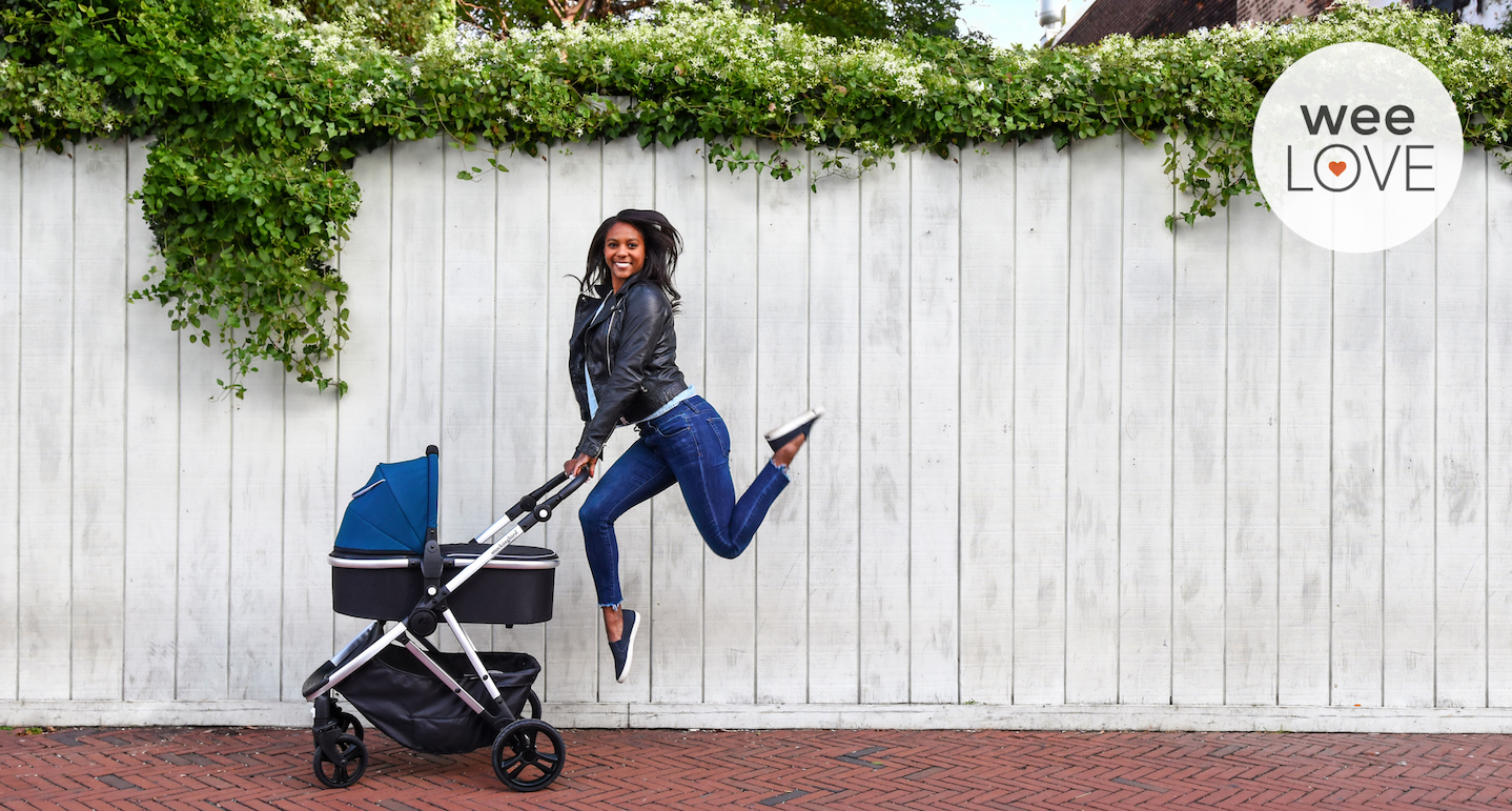 woman jumping next to mocking bird stroller