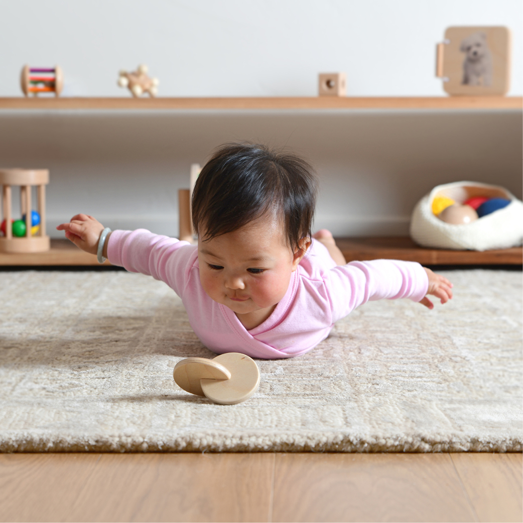 Baby Playing with Monti Kids Montessori toy