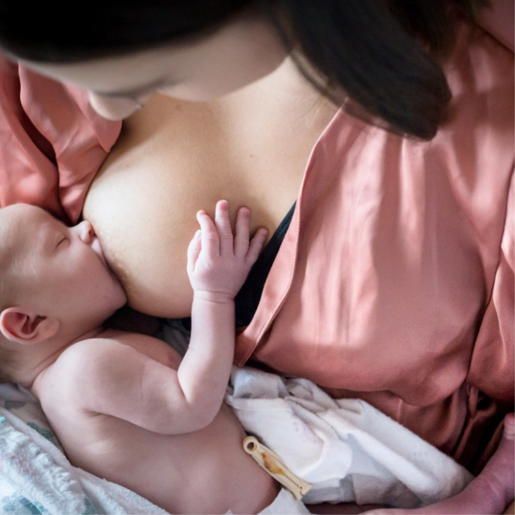A Woman Breastfeeds Her Baby